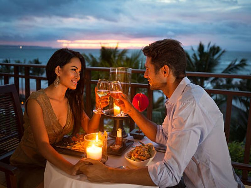 young couple enjoying a romantic dinner by candlelight, outdoor